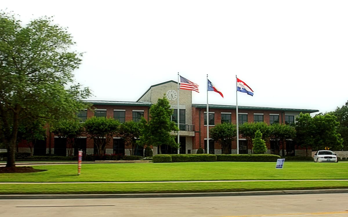 Friendswood City Hall and flags on the lawn
