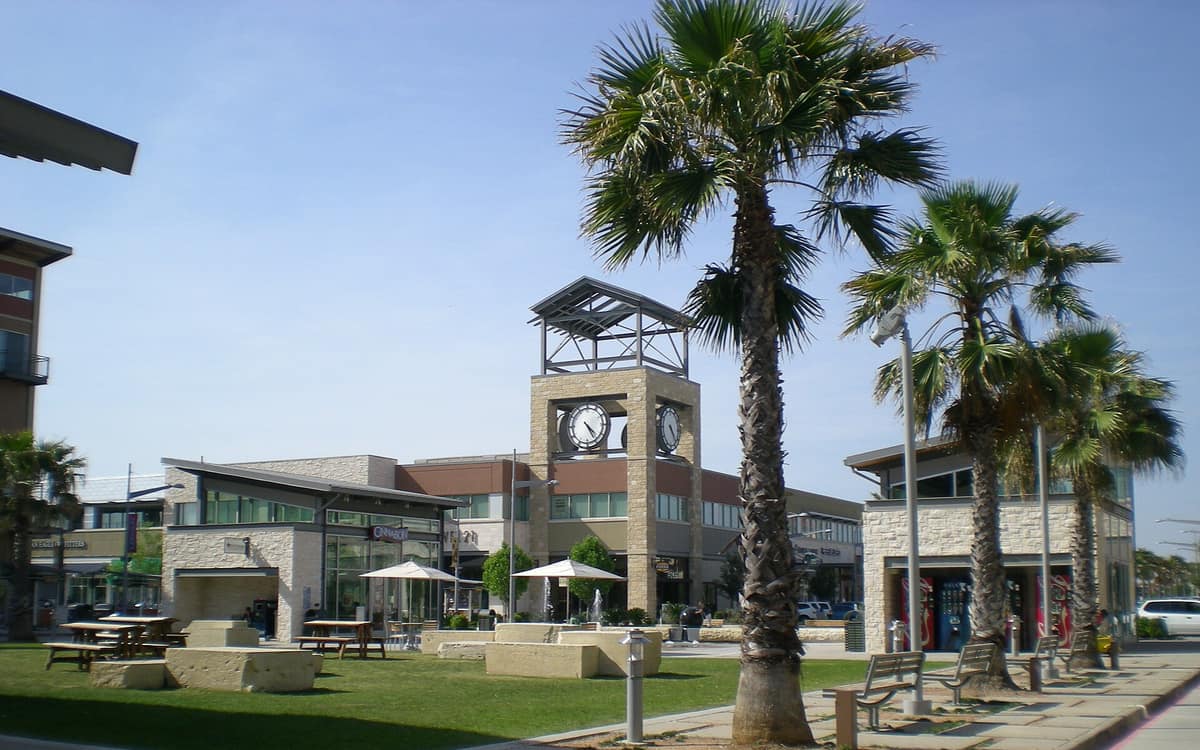 Pearland Town Center plaza with a clock tower and palm trees